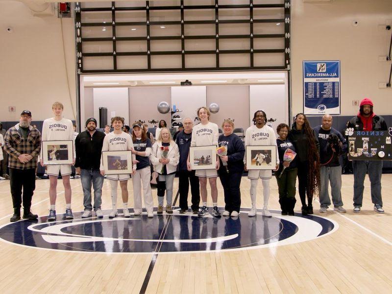 A group photo from the 2025 Penn State DuBois men’s basketball team senior day festivities. Members of the team that were honored are joined by family members on the PAW Center court.